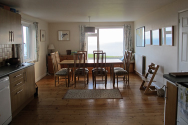 The kitchen diner and view of the sea beyond